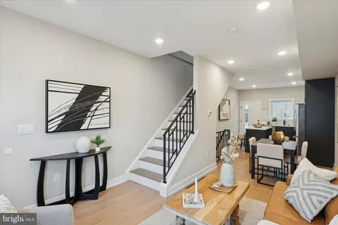a living room with furniture and a painting on the wall