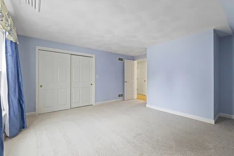 a view of an empty room and entryway