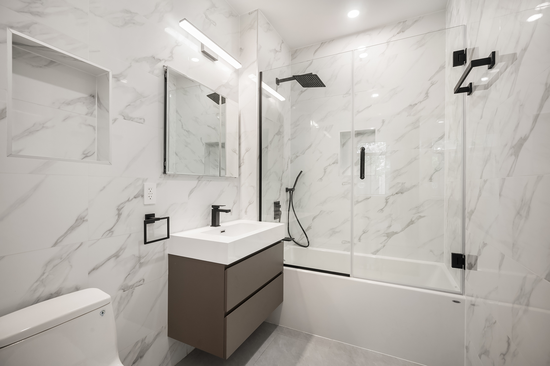 61 West 70th Street, Unit 2B Manhattan, NY 10023 - Photo 6 of 7 a bathroom with a sink toilet tub and shower