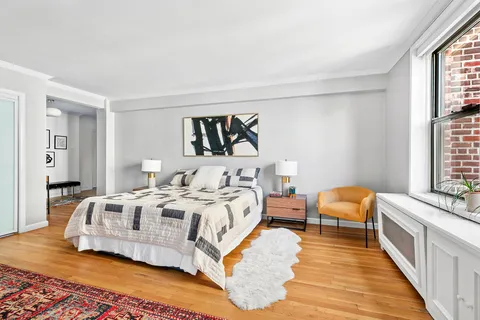 a bed room with bed and a window