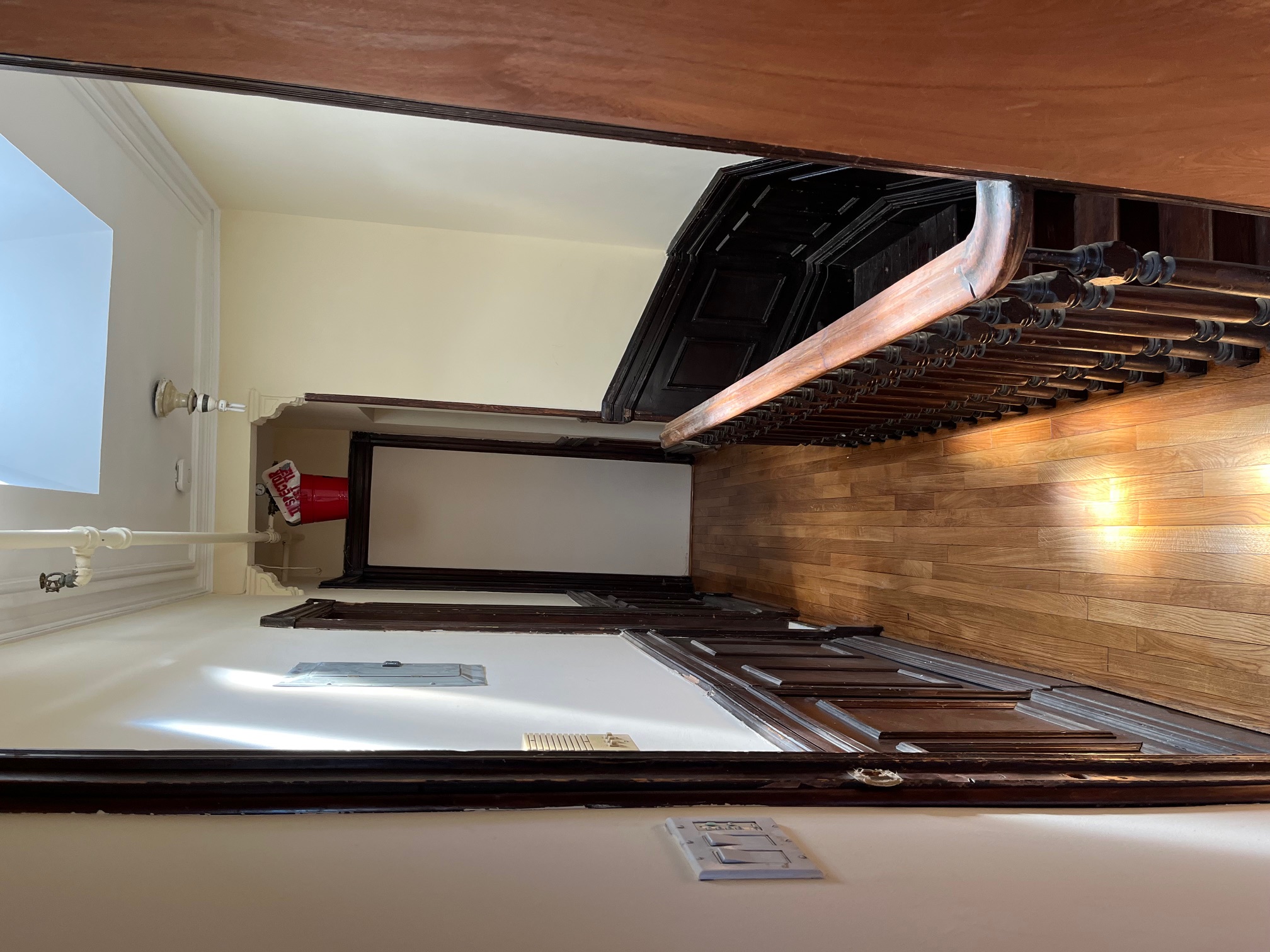 106 West 131st Street Manhattan, NY 10027 - Photo 8 of 16 a view of a hallway with wooden floor and staircase