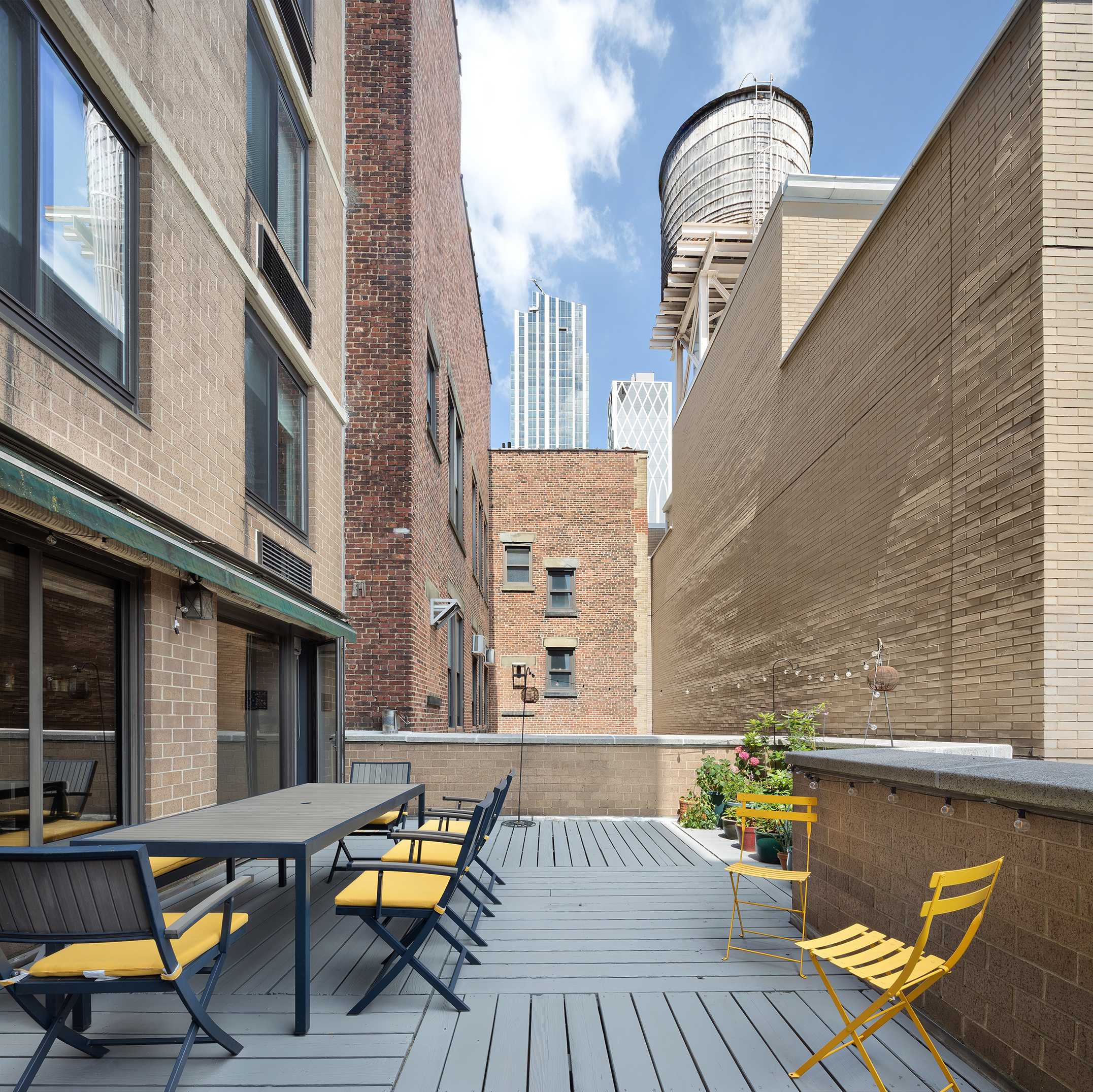 111 East 30th Street, Unit 16C Manhattan, NY 10016 - Photo 9 of 13 a view of balcony with two chairs and wooden floor