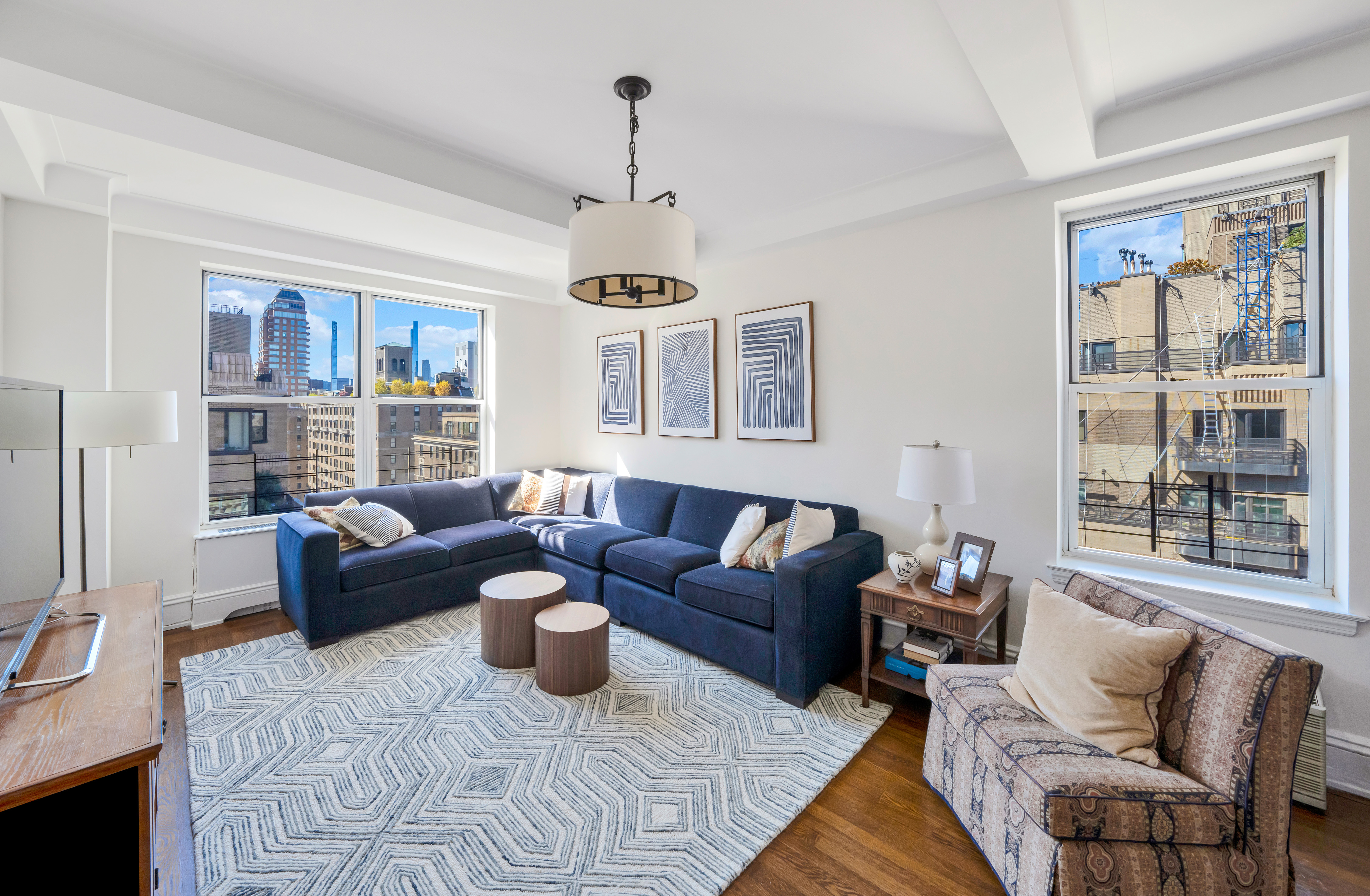 47 East 88th Street, Unit 15A Manhattan, NY 10128 - Photo 15 of 21 a living room with furniture ceiling fan and a window
