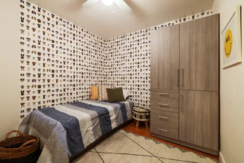 a bedroom with a bed and a chair