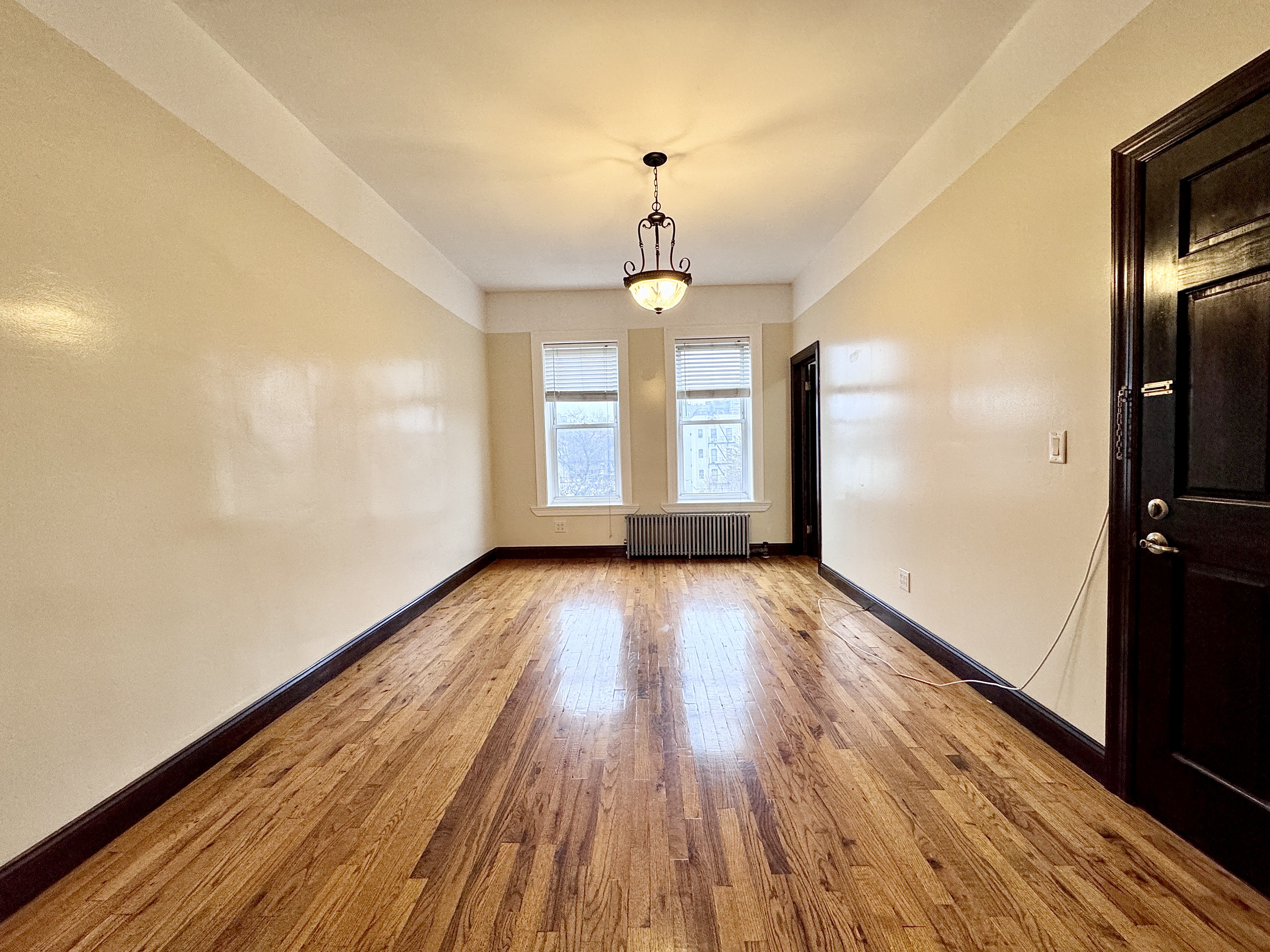 497 Park Place, Unit 4 Brooklyn, NY 11238 - Photo 7 of 14 a view of empty room with wooden floor and fan