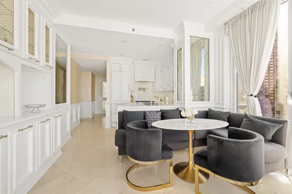 a dining room with furniture and a large window