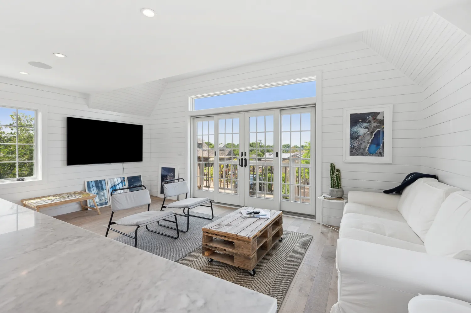a living room with furniture and a floor to ceiling window