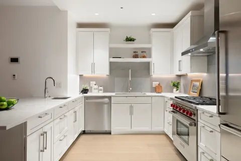 a kitchen with stainless steel appliances granite countertop a sink stove and cabinets