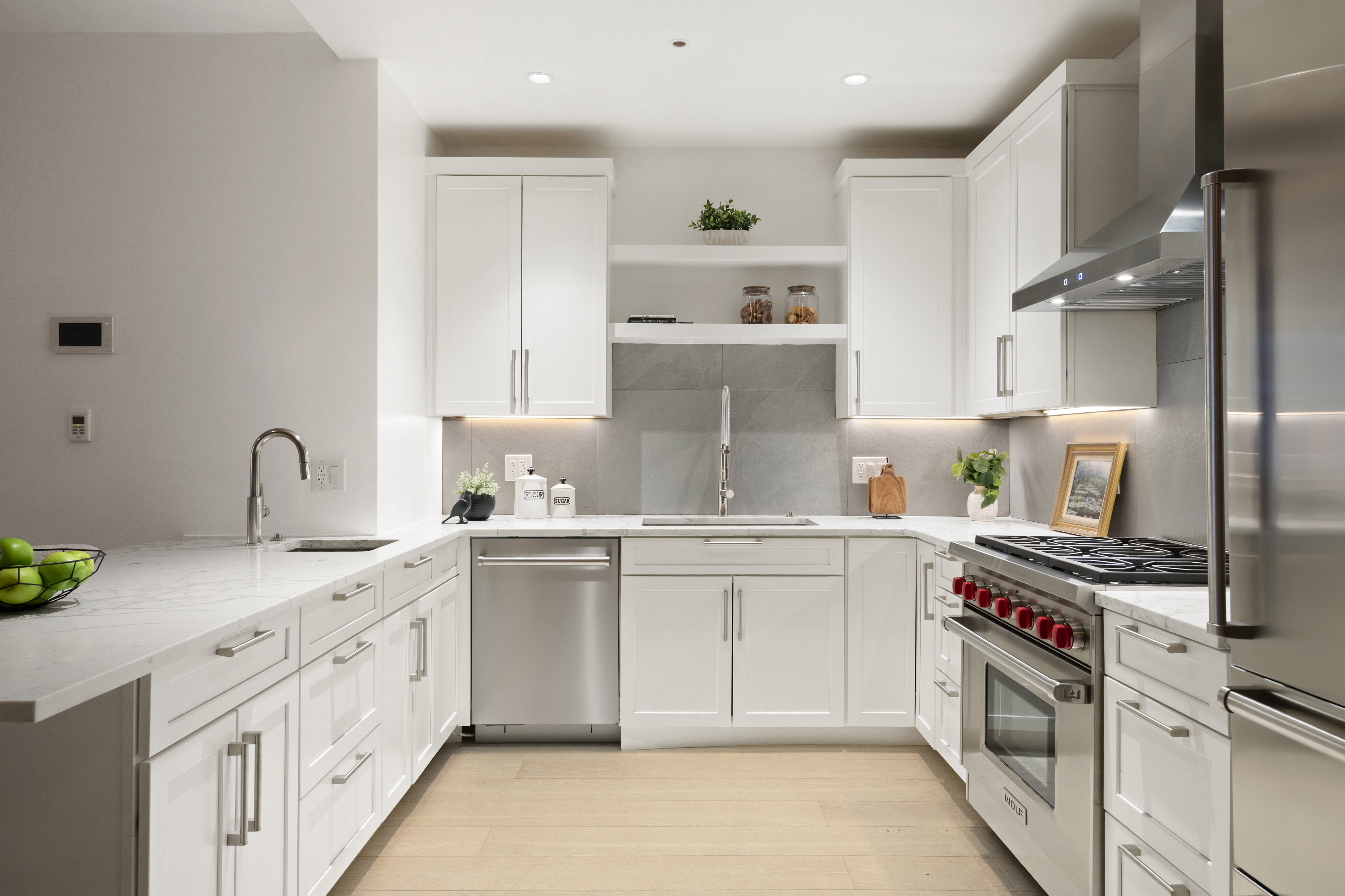48 West 22nd Street, Unit 2 Manhattan, NY 10010 - Photo 4 of 8 a kitchen with stainless steel appliances granite countertop a sink stove and cabinets