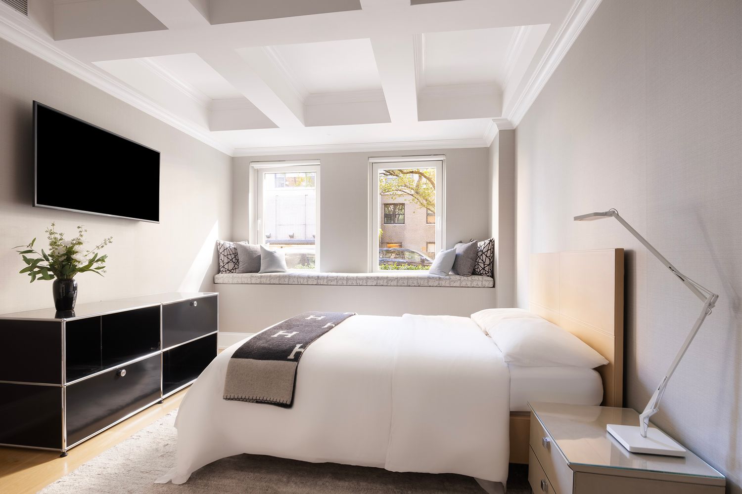 554 East 82nd Street, Unit 1/2 Manhattan, NY 10028 - Photo 8 of 13 a bedroom with a large bed and a flat tv screen on dresser