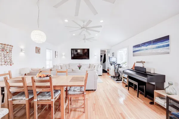 a view of a dining room with furniture and wooden floor