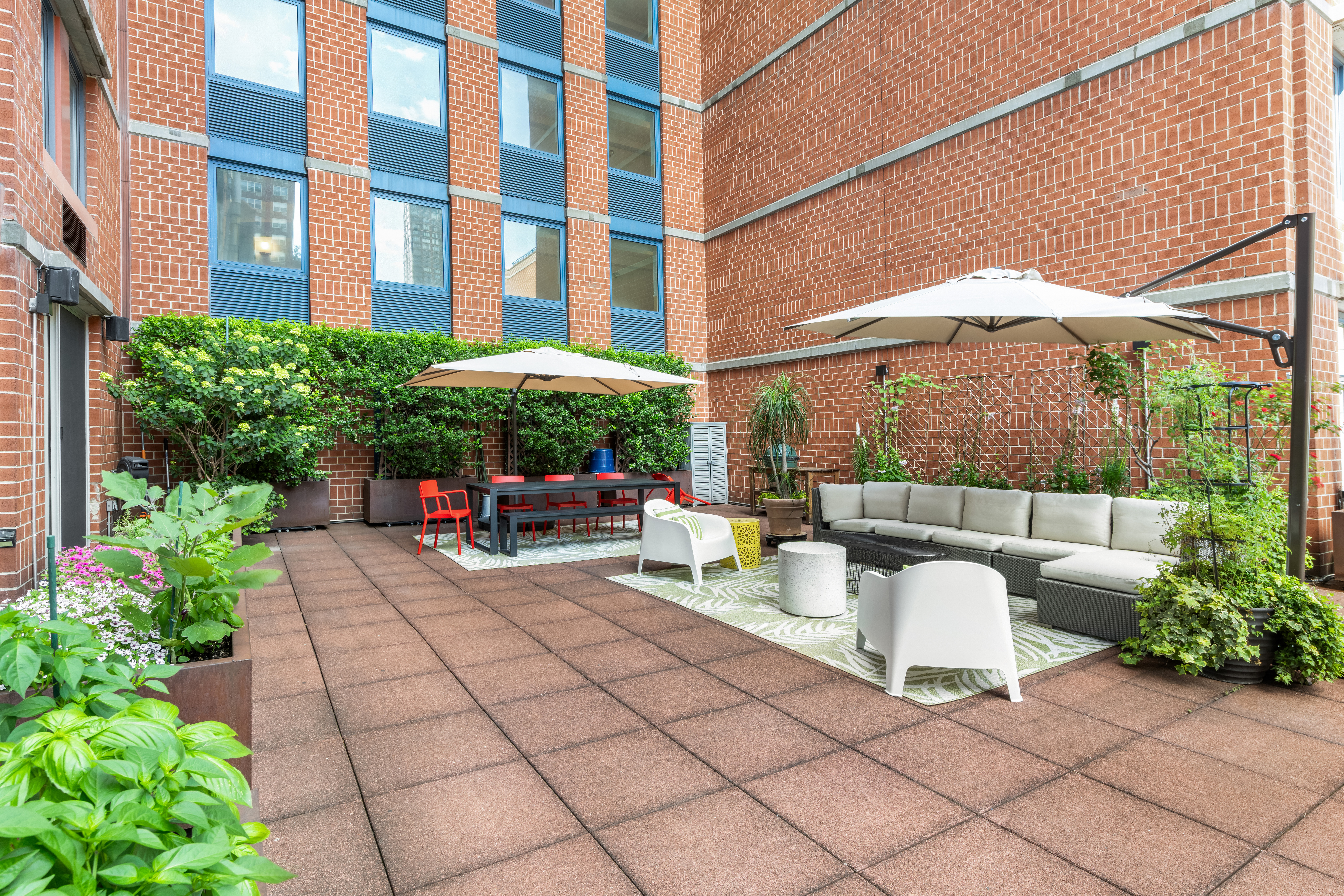 404 East 76th Street, Unit 2B Manhattan, NY 10021 - Photo 9 of 24 a view of a patio with a table and chairs under an umbrella