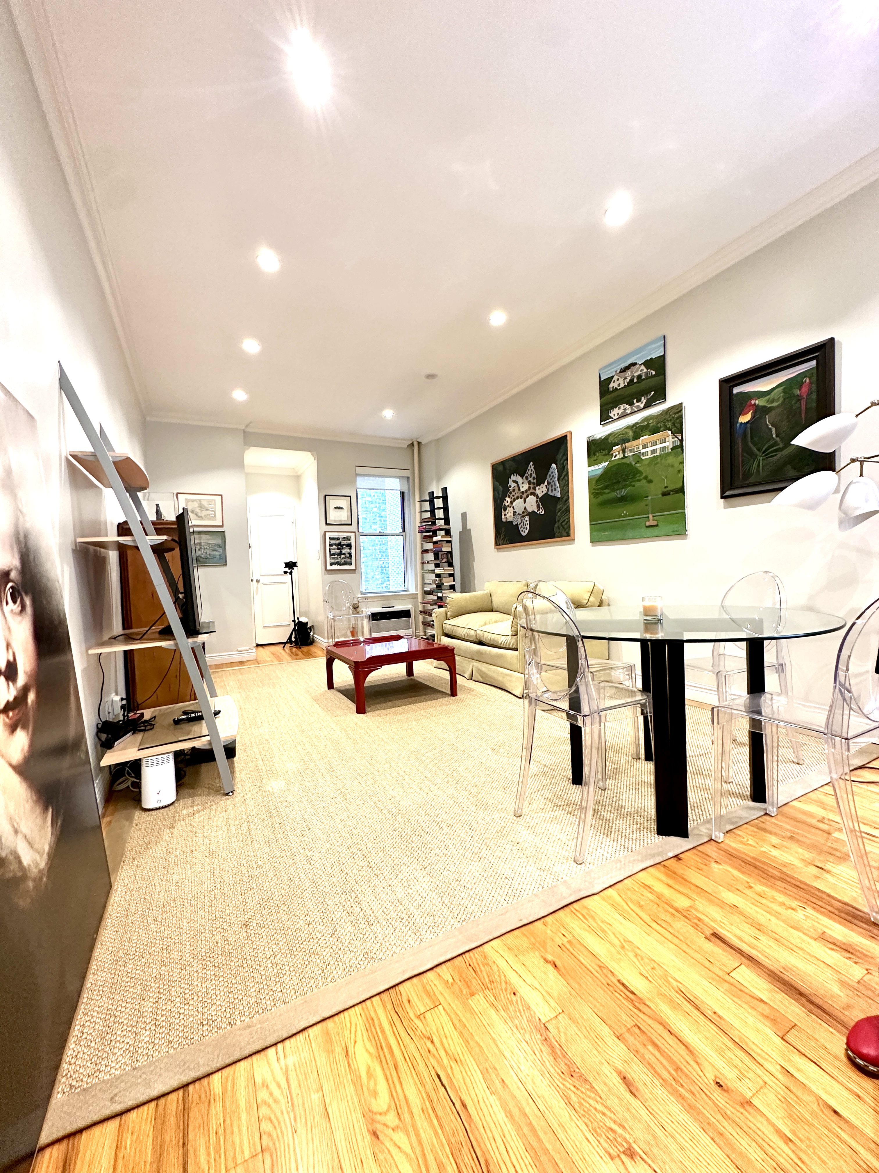 20 East 88th Street, Unit 5B Manhattan, NY 10128 - Photo 6 of 8 a living room with furniture and a flat screen tv