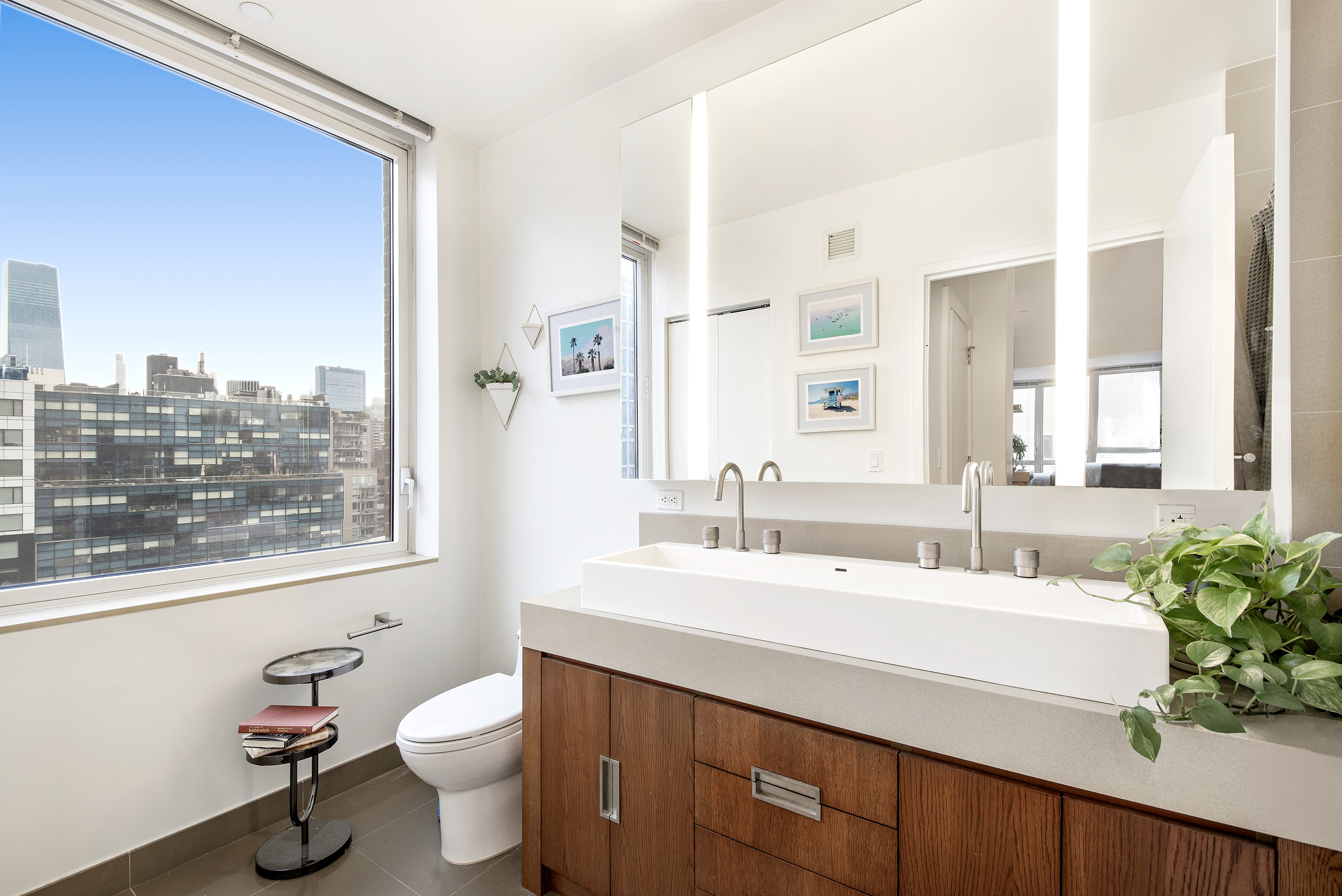 450 West 17th Street, Unit 1021 Manhattan, NY 10011 - Photo 4 of 5 a bathroom with a sink mirror vanity and toilet