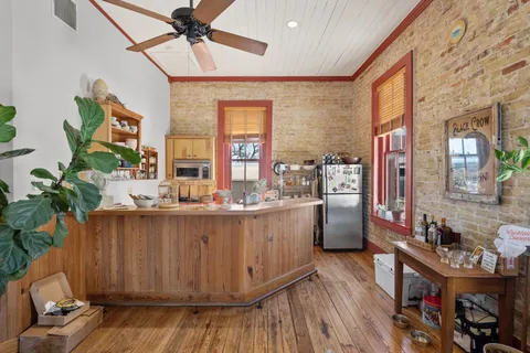 a view of a kitchen with stainless steel appliances and chandelier