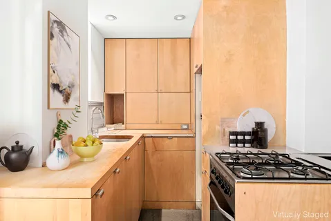 a kitchen with a sink stove and cabinets
