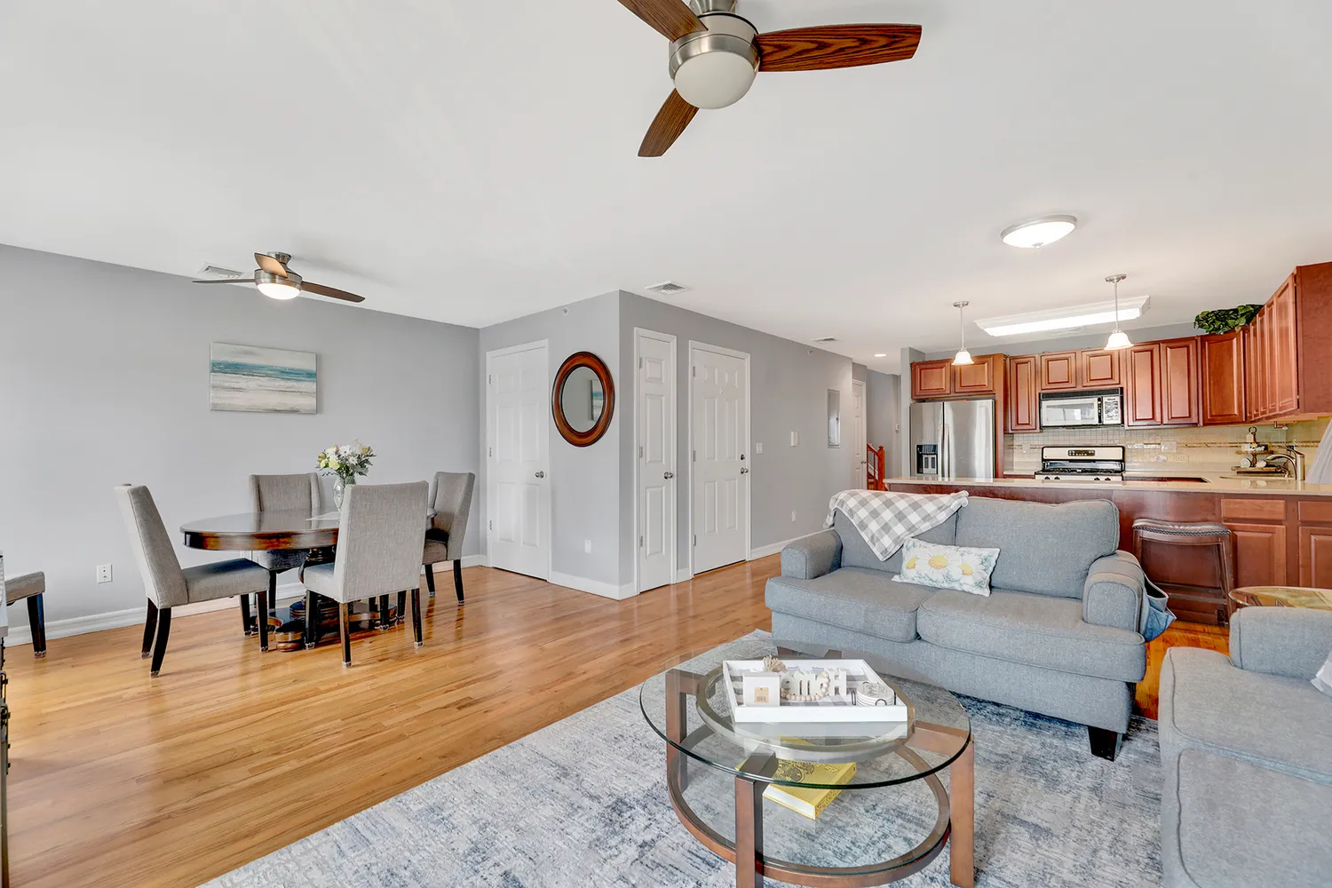 a living room with furniture and view of kitchen