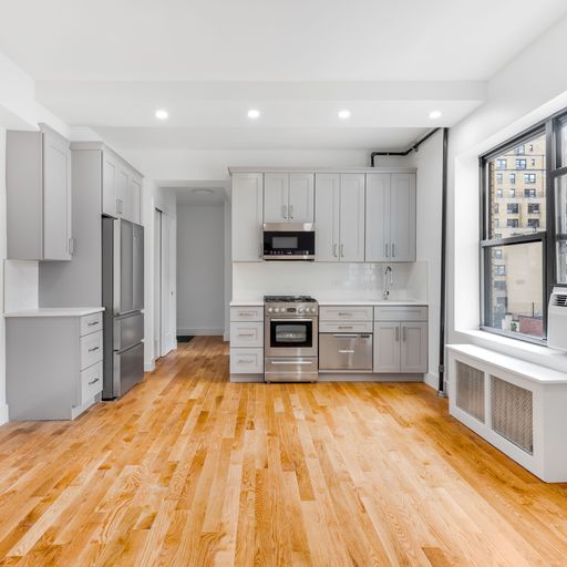 a kitchen with stainless steel appliances kitchen island granite countertop a refrigerator and a stove top oven