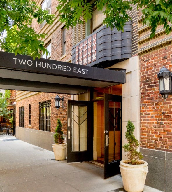 200 East 16th Street, Unit 2M Manhattan, NY 10003 - Photo 5 of 11 a front view of a building with potted plants