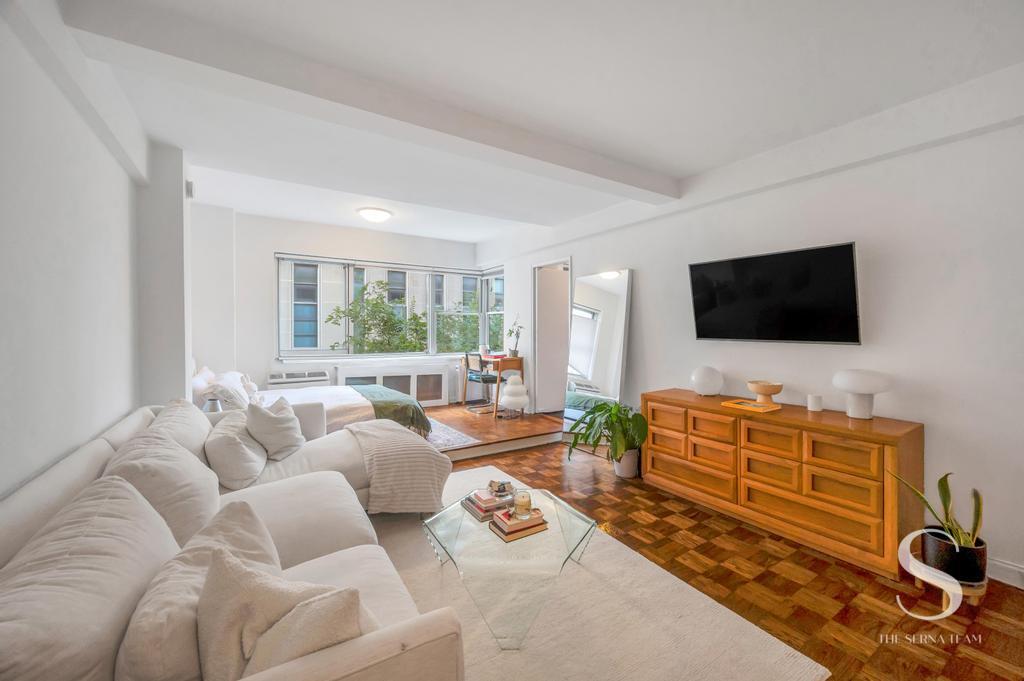 7 Lexington Avenue, Unit 5E Manhattan, NY 10010 - Photo 1 of 27 a living room with furniture and a flat screen tv