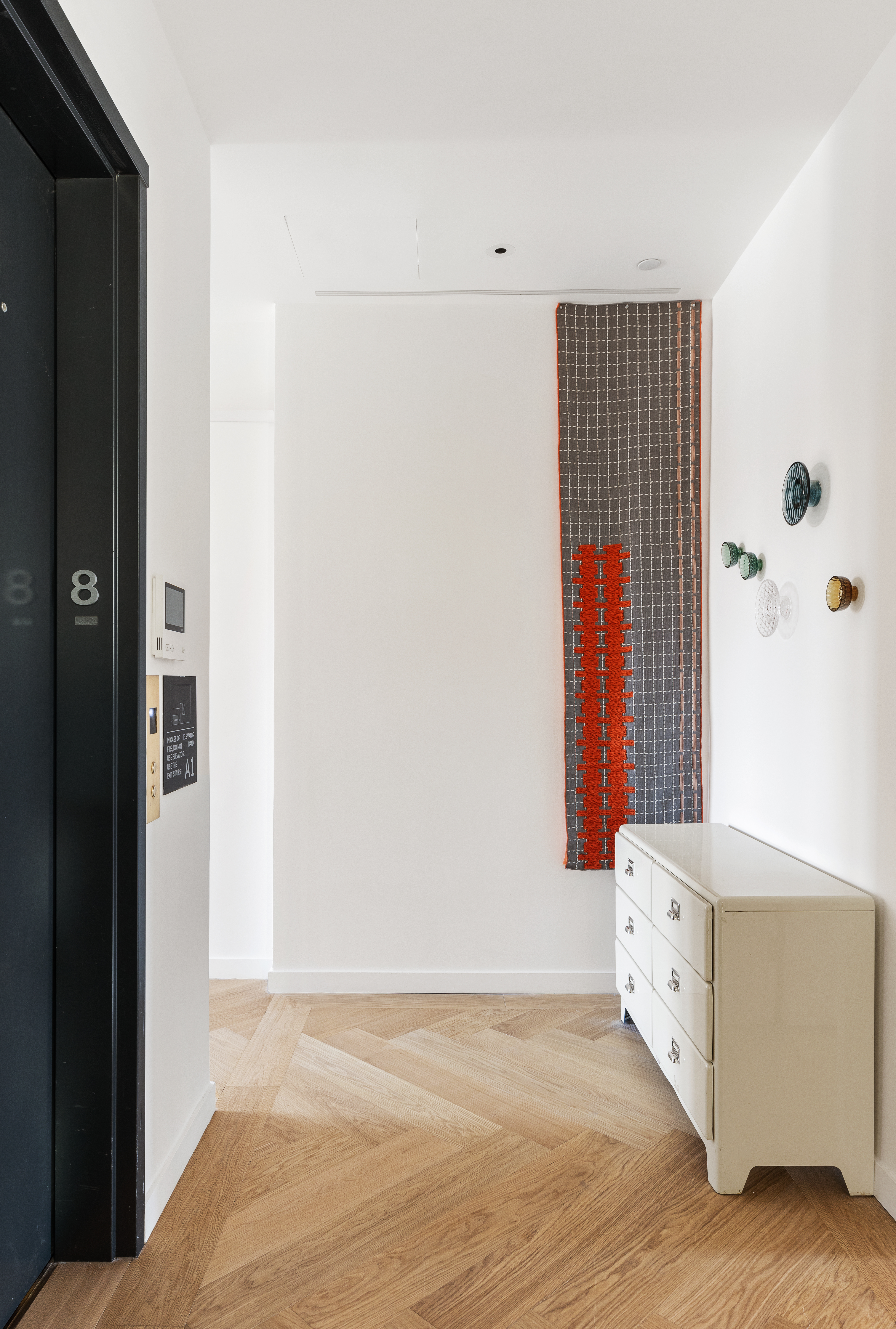 500 West 25th Street, Unit 8 Manhattan, NY 10001 - Photo 8 of 18 a view of an empty room with wooden floor and a cabinet
