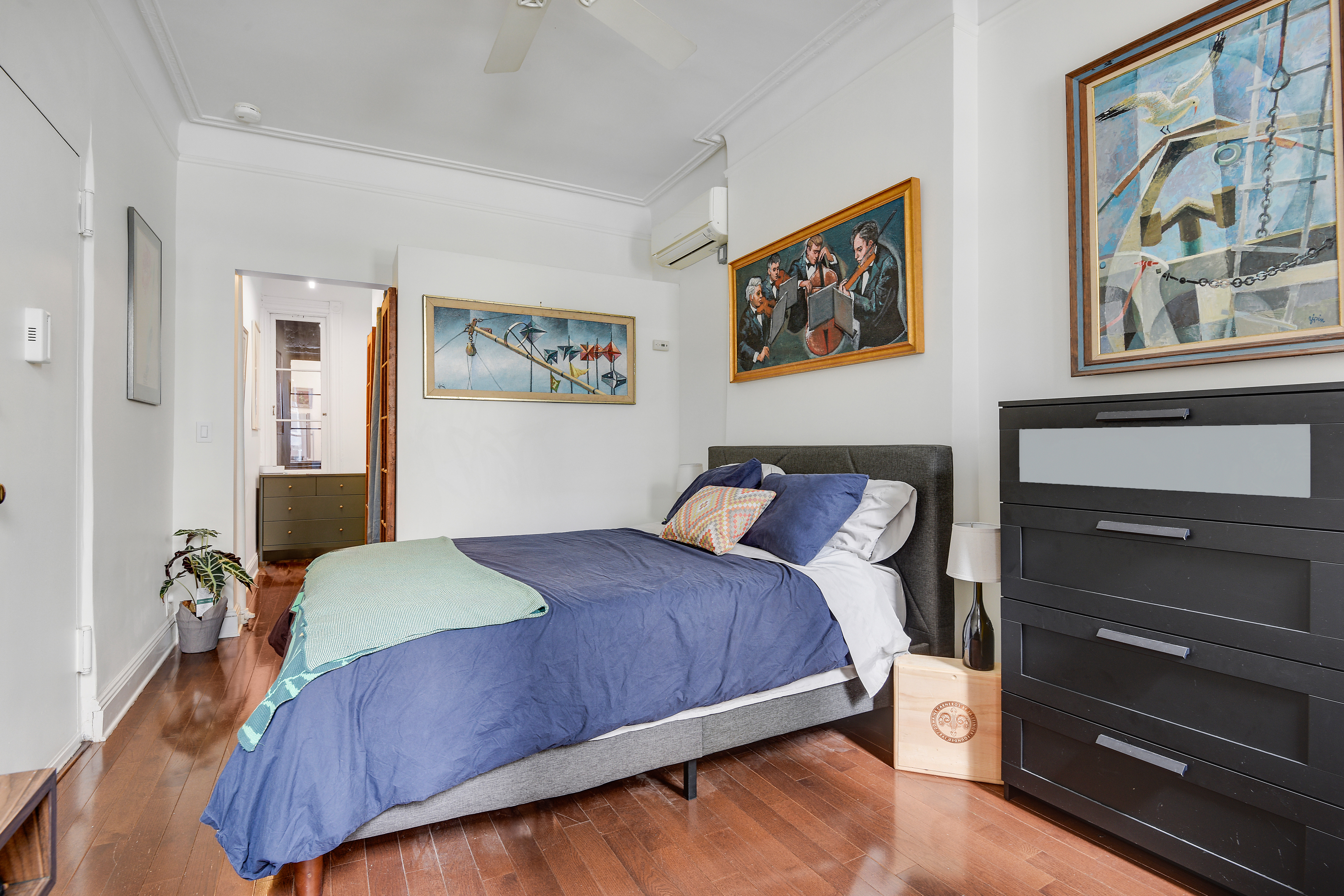 436 East 66th Street, Unit 1W Manhattan, NY 10065 - Photo 13 of 19 a bedroom with a bed and a painting on the wall