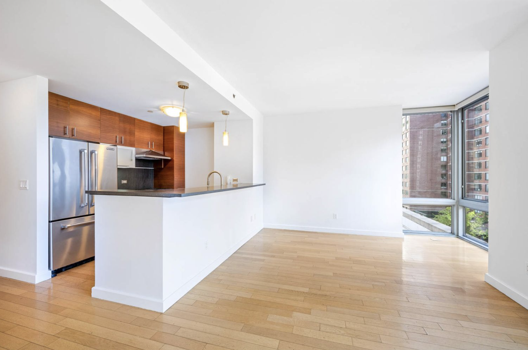 225 West 60th Street, Unit 8F Manhattan, NY 10023 - Photo 3 of 11 a view of kitchen with stainless steel appliances wooden floor and chair