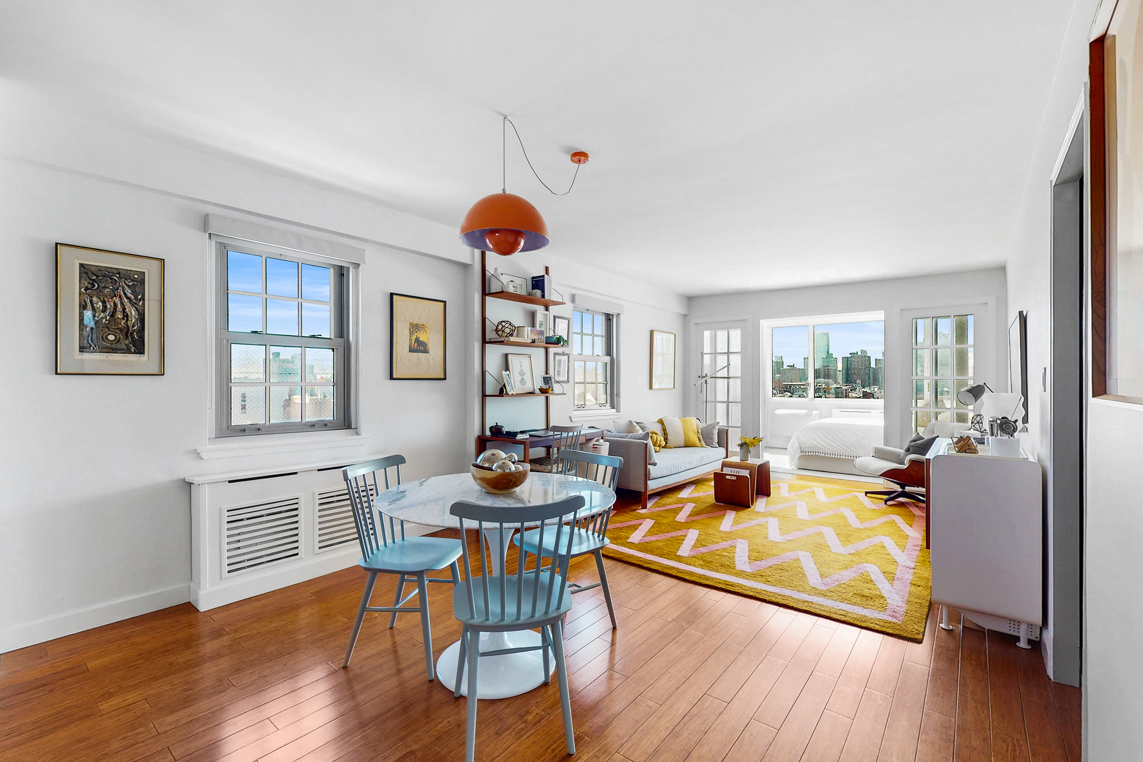 333 East 14th Street, Unit 10D Manhattan, NY 10003 - Photo 1 of 8 a living room with furniture and a wooden floor