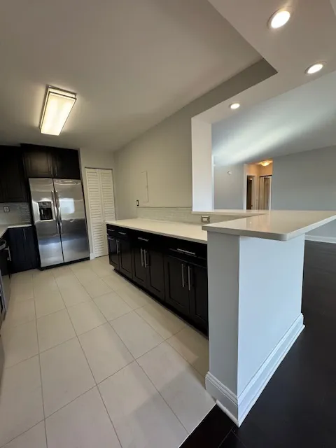 a kitchen with stainless steel appliances granite countertop a sink and cabinets
