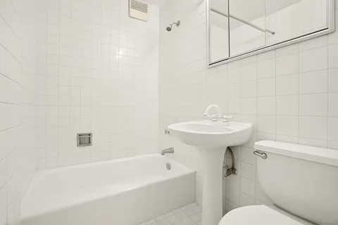 a white bath tub sitting next to a white sink
