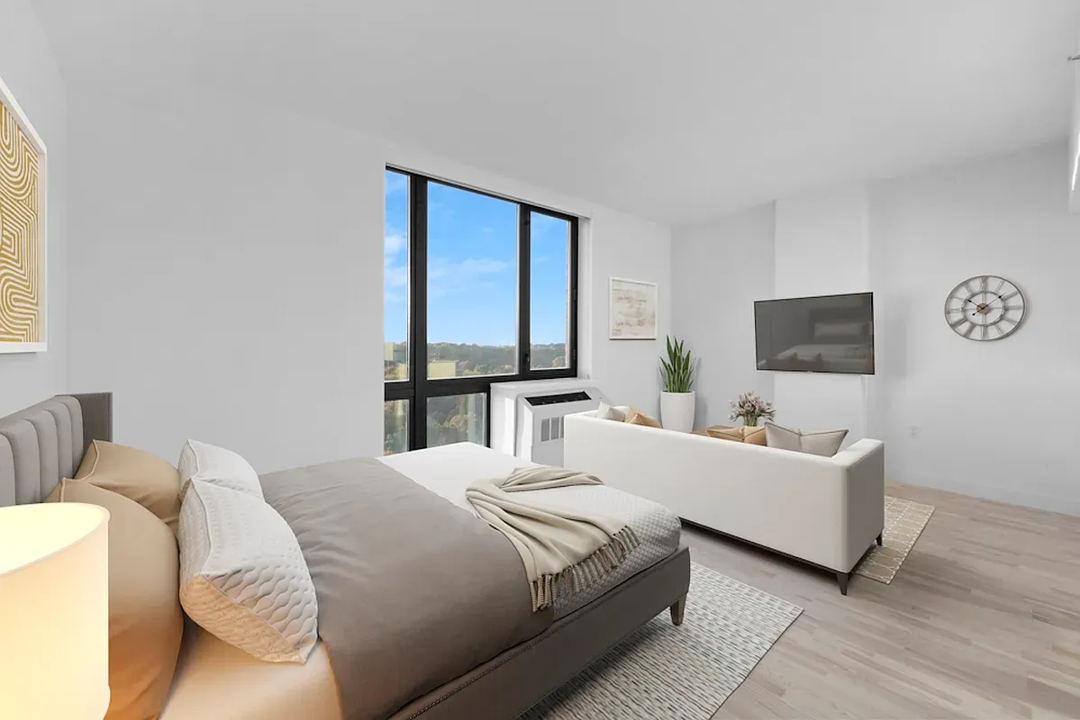 a bedroom with a bed and a flat screen tv