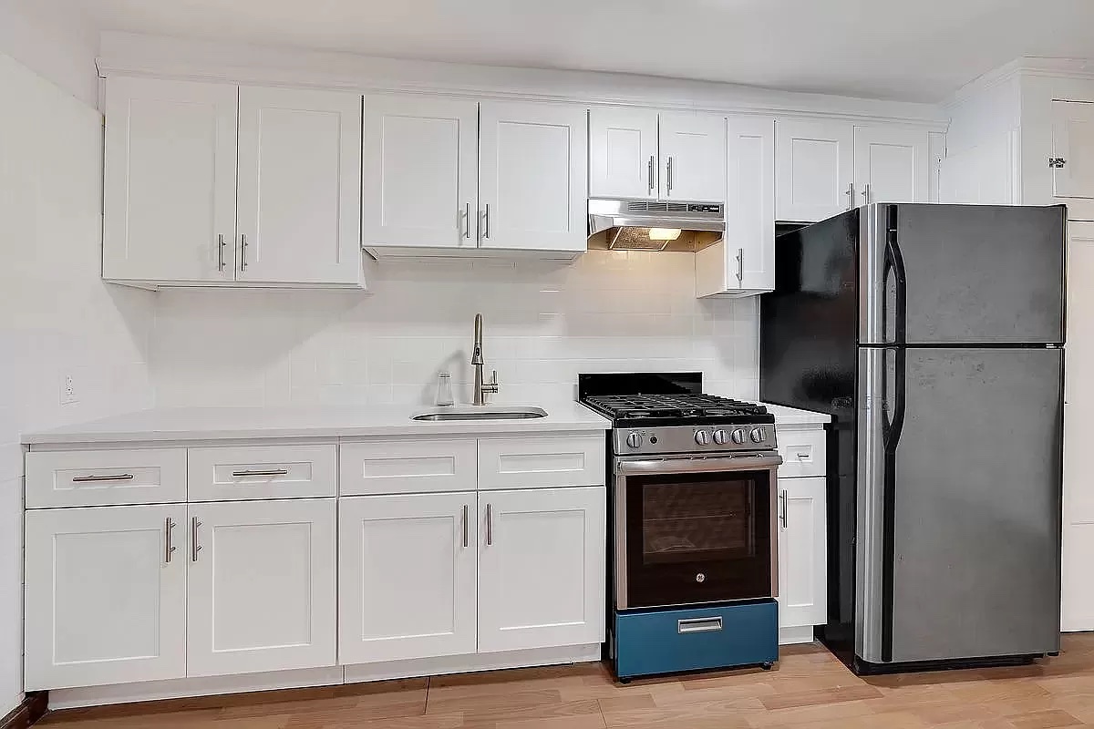 458 West 153 Street Manhattan, NY 10031 - Photo 12 of 16 a kitchen with cabinets appliances and a counter space
