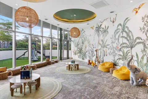 a living room with patio furniture and a floor to ceiling window