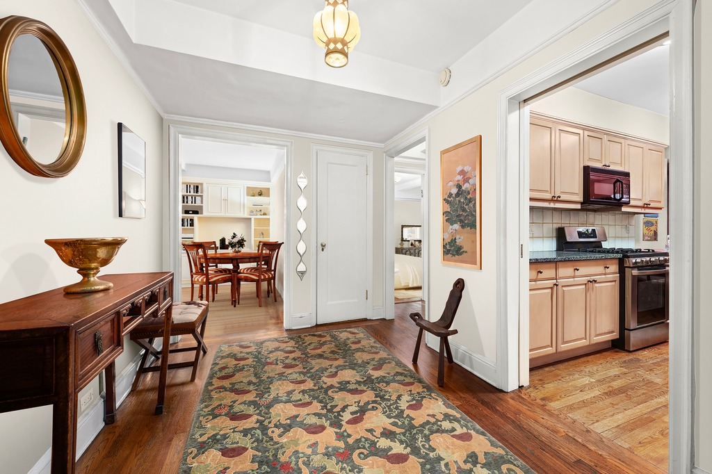 205 East 78th Street, Unit 12J Manhattan, NY 10075 - Photo 3 of 9 a living room with furniture a rug and a flat screen tv