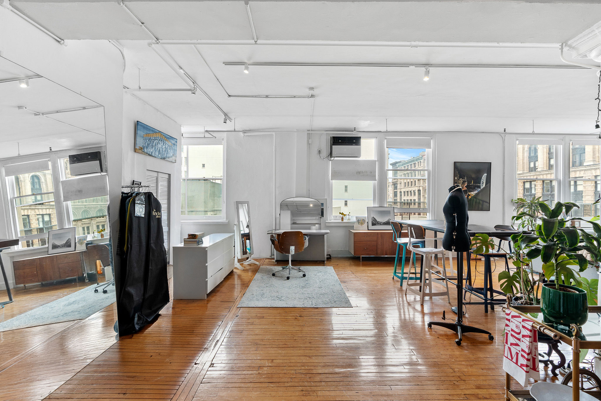 565 Broadway, Unit 8W Manhattan, NY 10012 - Photo 17 of 23 a living room with furniture large window and wooden floor