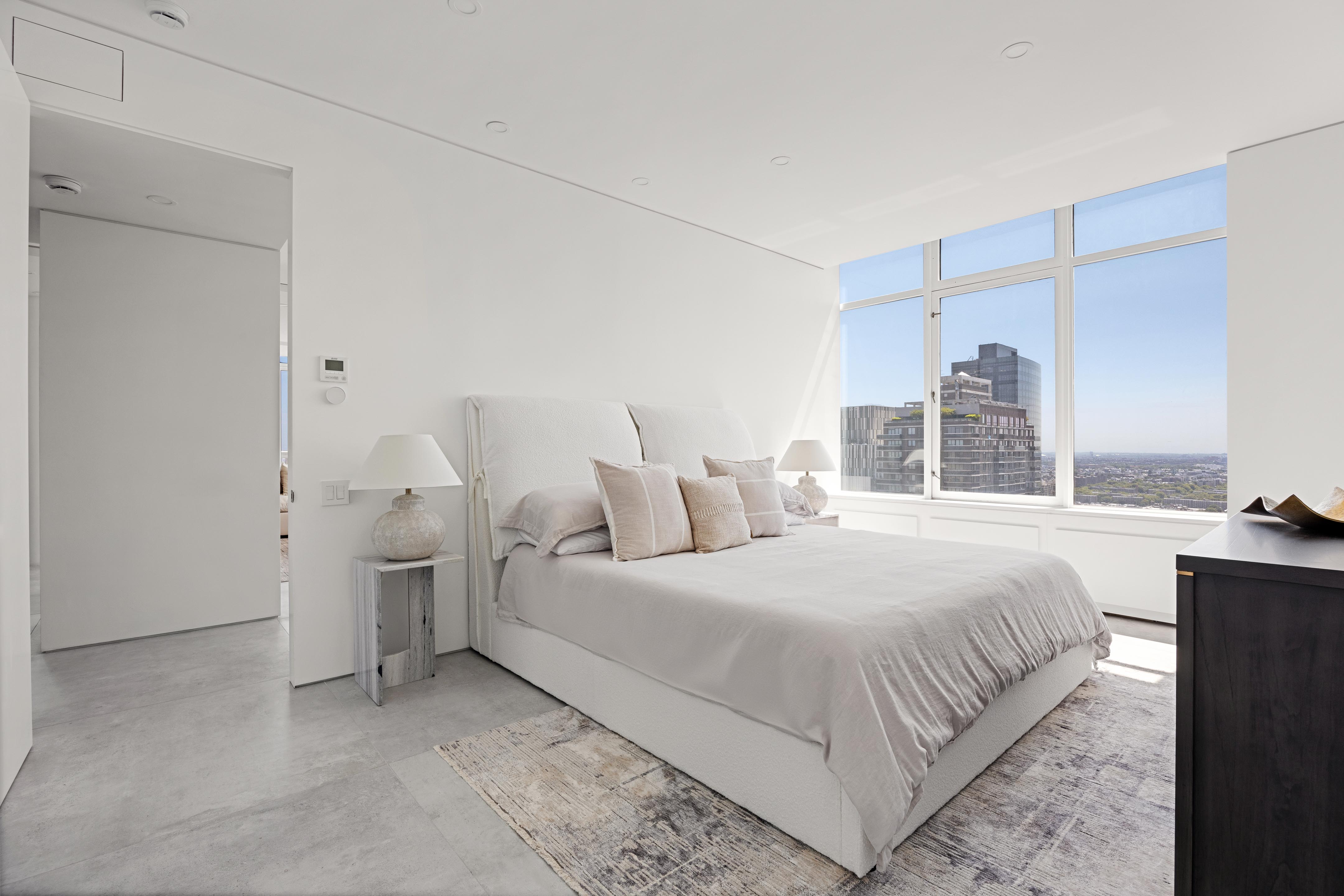 422 East 72nd Street, Unit 37AD Manhattan, NY 10021 - Photo 15 of 38 a bedroom with a bed and a night stand