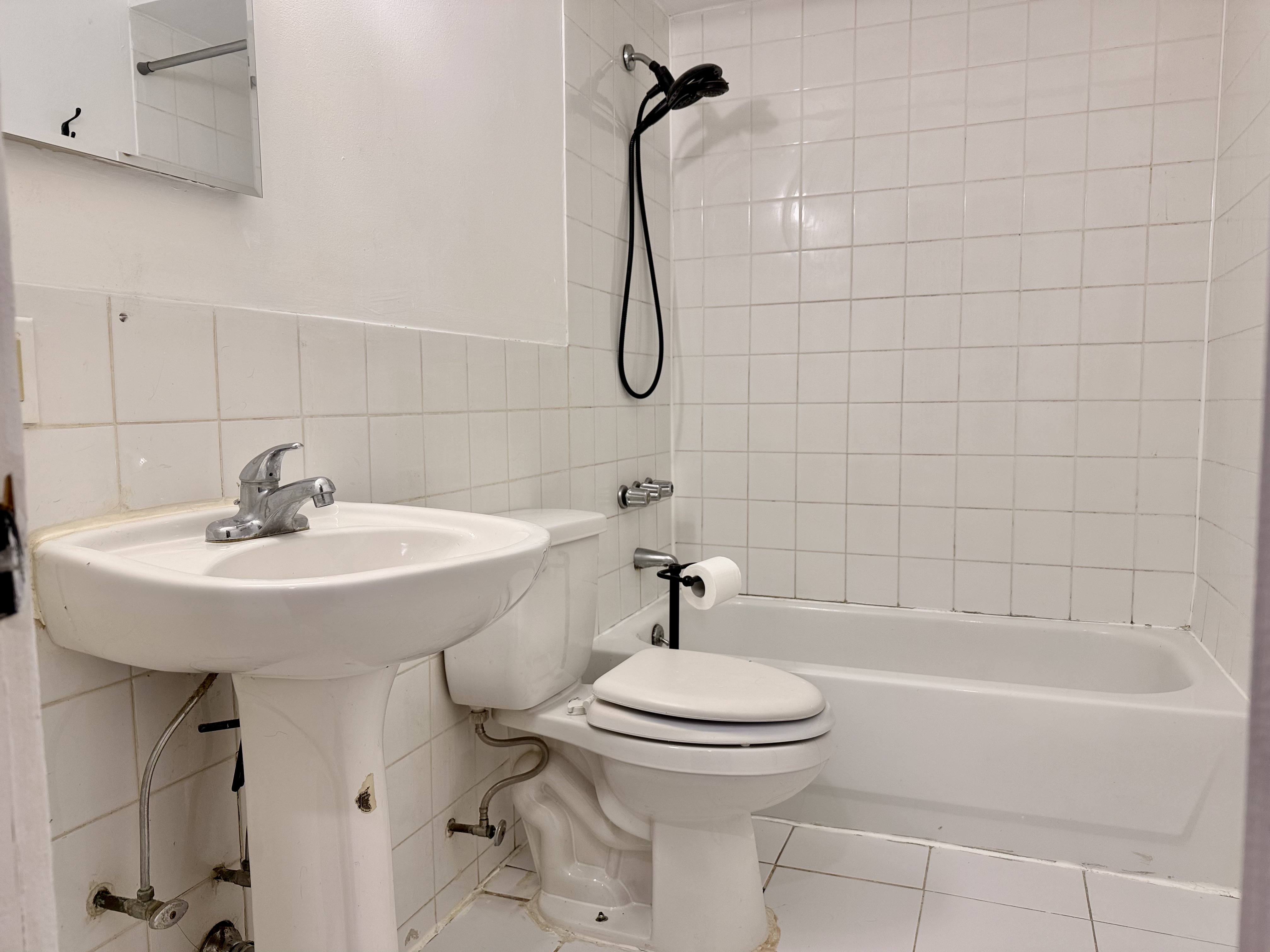 1997 3rd Avenue, Unit 1A Manhattan, NY 10029 - Photo 13 of 23 a bathroom with a sink a toilet and a bathtub