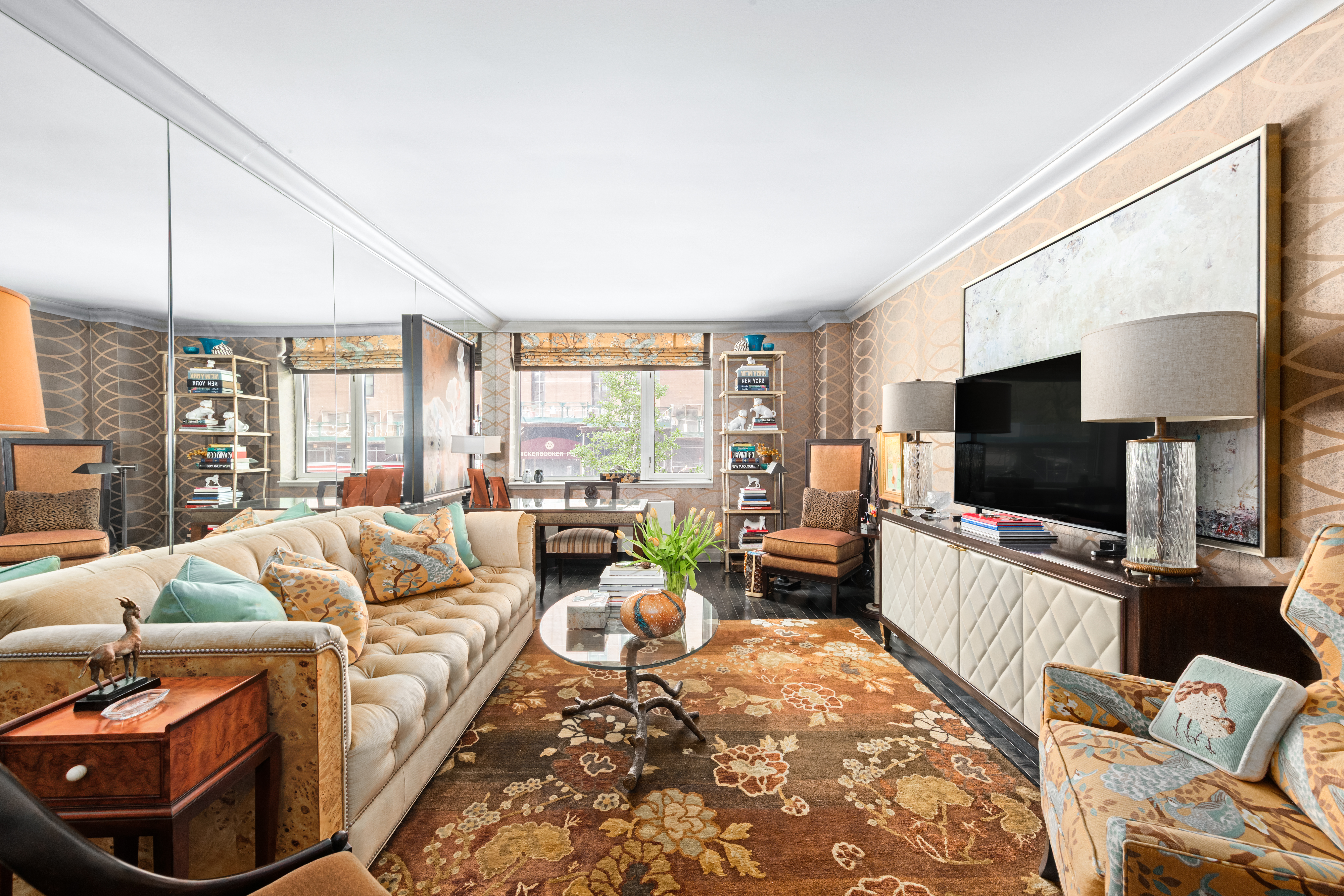 a living room with furniture a flat screen tv and a large window