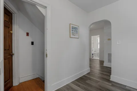 a view of a room with wooden floor