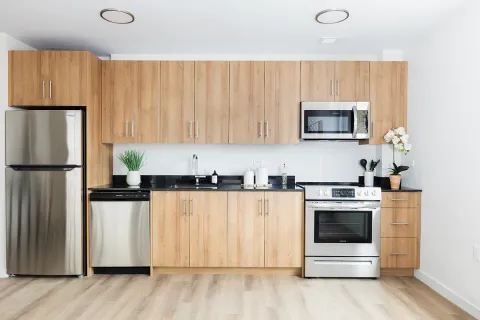 a kitchen with stainless steel appliances a stove a microwave and a refrigerator