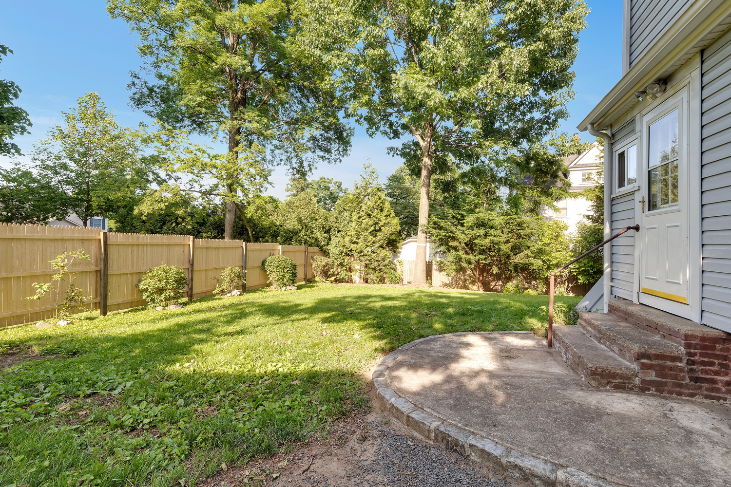 242-09 Pine Street Queens, NY 11363 - Photo 19 of 21 a backyard of a house with a yard and outdoor seating