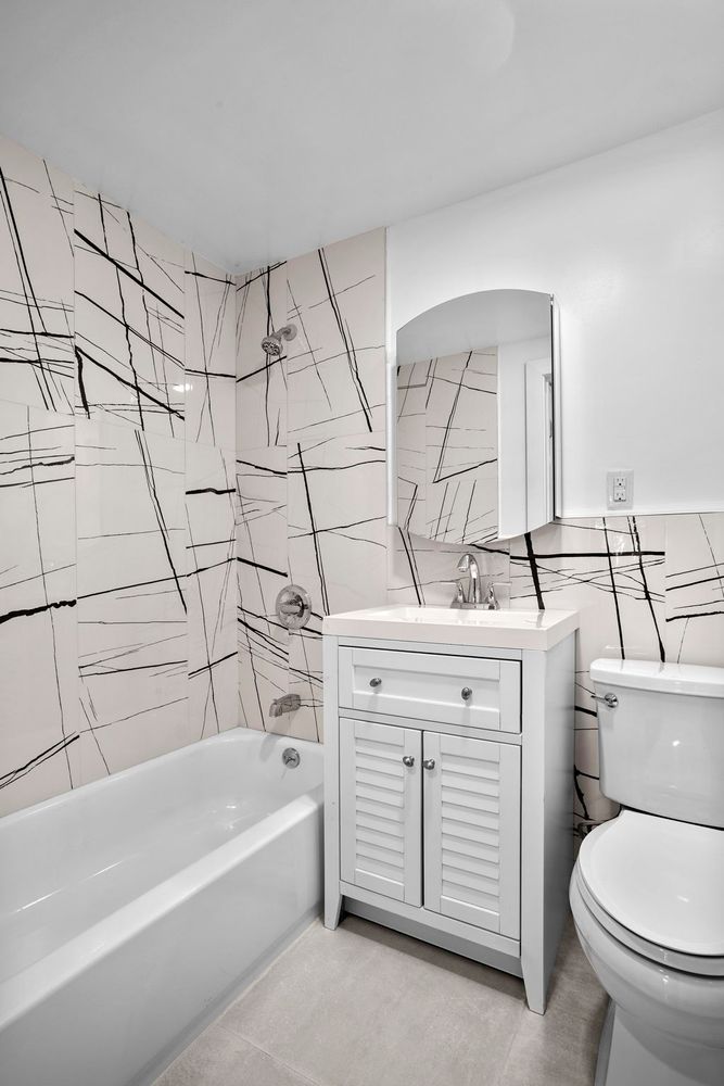 791 Lexington Avenue, Unit 2 Brooklyn, NY 11221 - Photo 16 of 19 a view of bathroom with bathtub and toilet