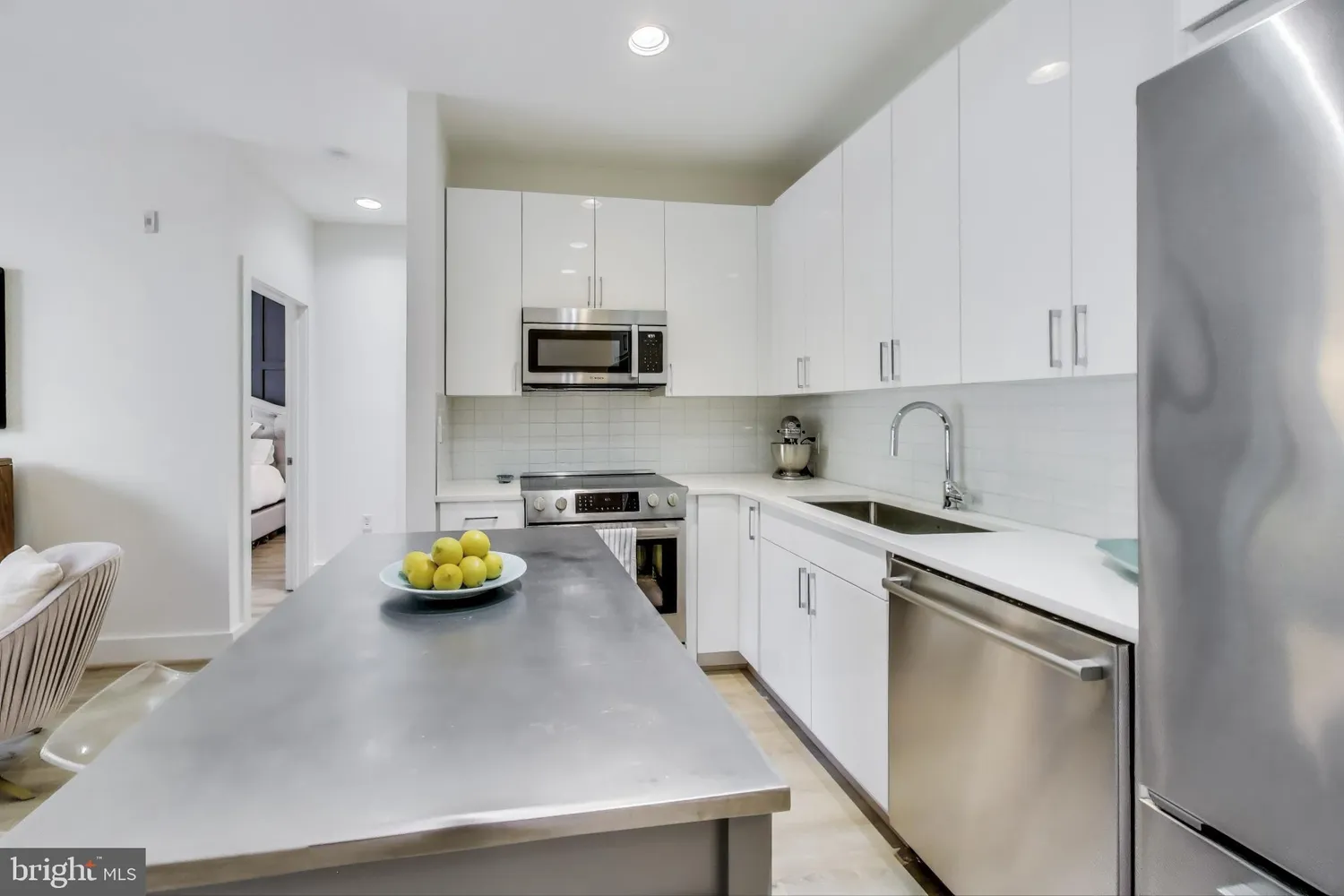 a kitchen with a sink a stove and chairs