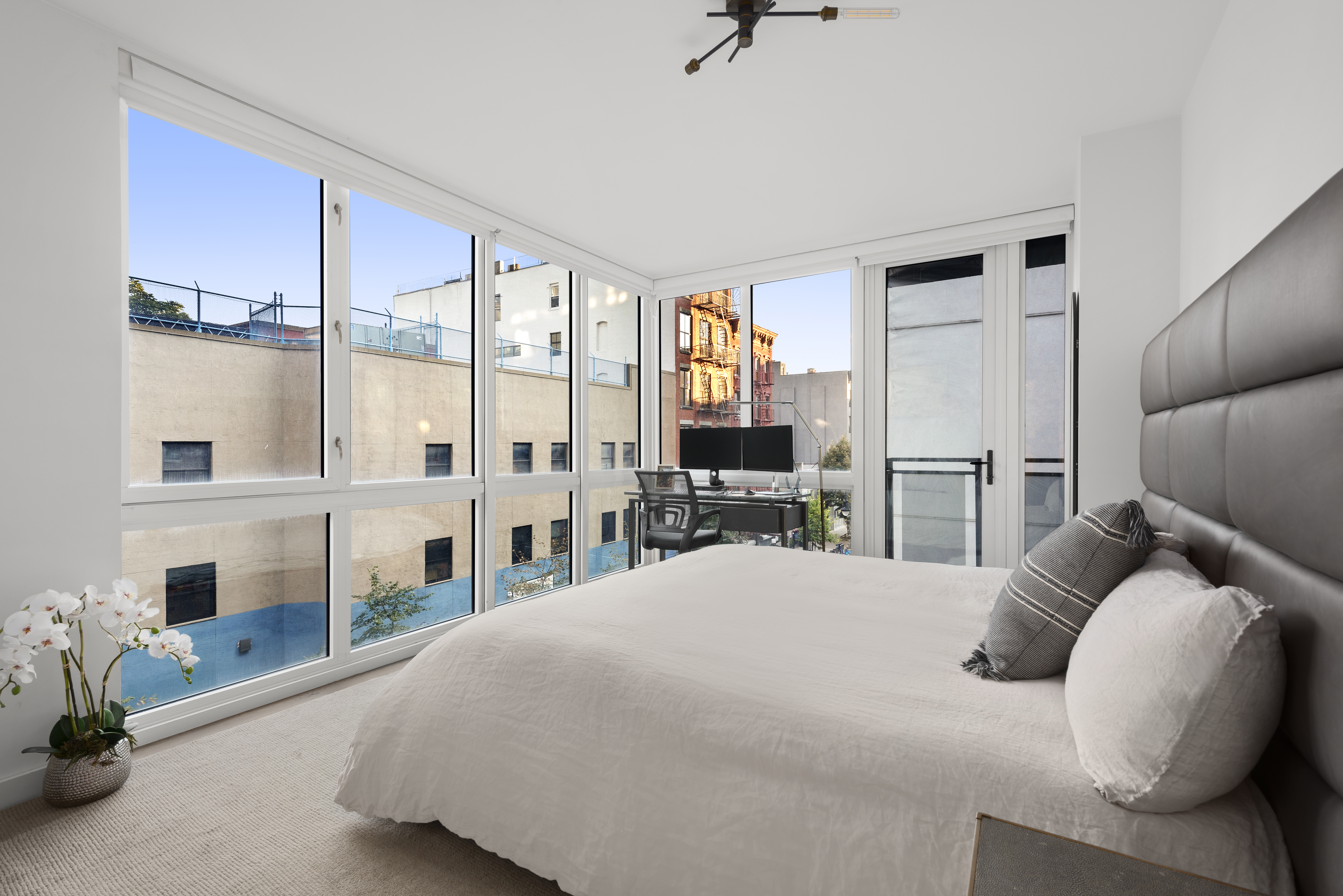 265 East Houston Street, Unit 4 Manhattan, NY 10002 - Photo 9 of 20 a bedroom with a bed and a large window