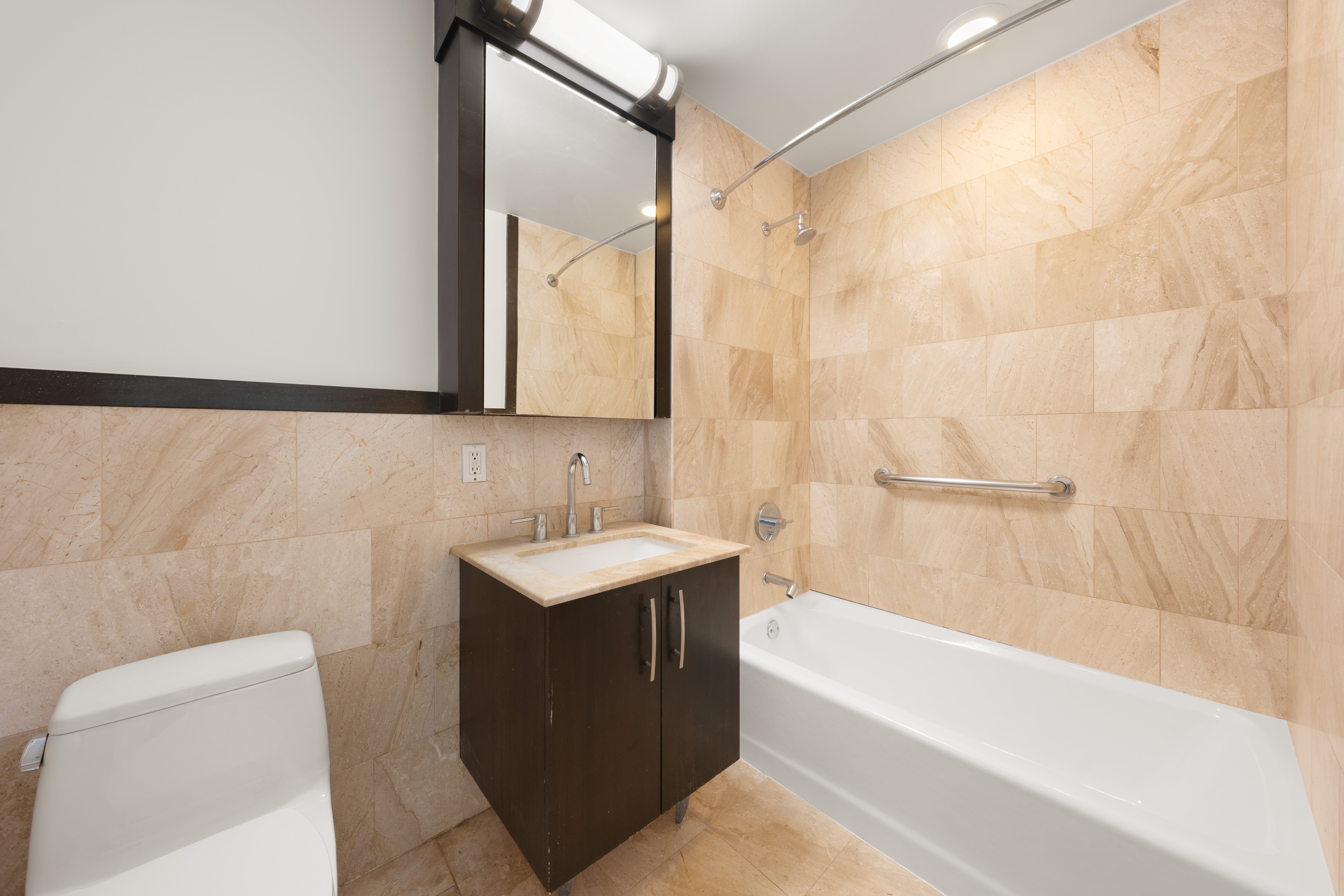 161 East 110th Street, Unit 6A Manhattan, NY 10029 - Photo 8 of 10 a bathroom with a sink mirror toilet and bathtub