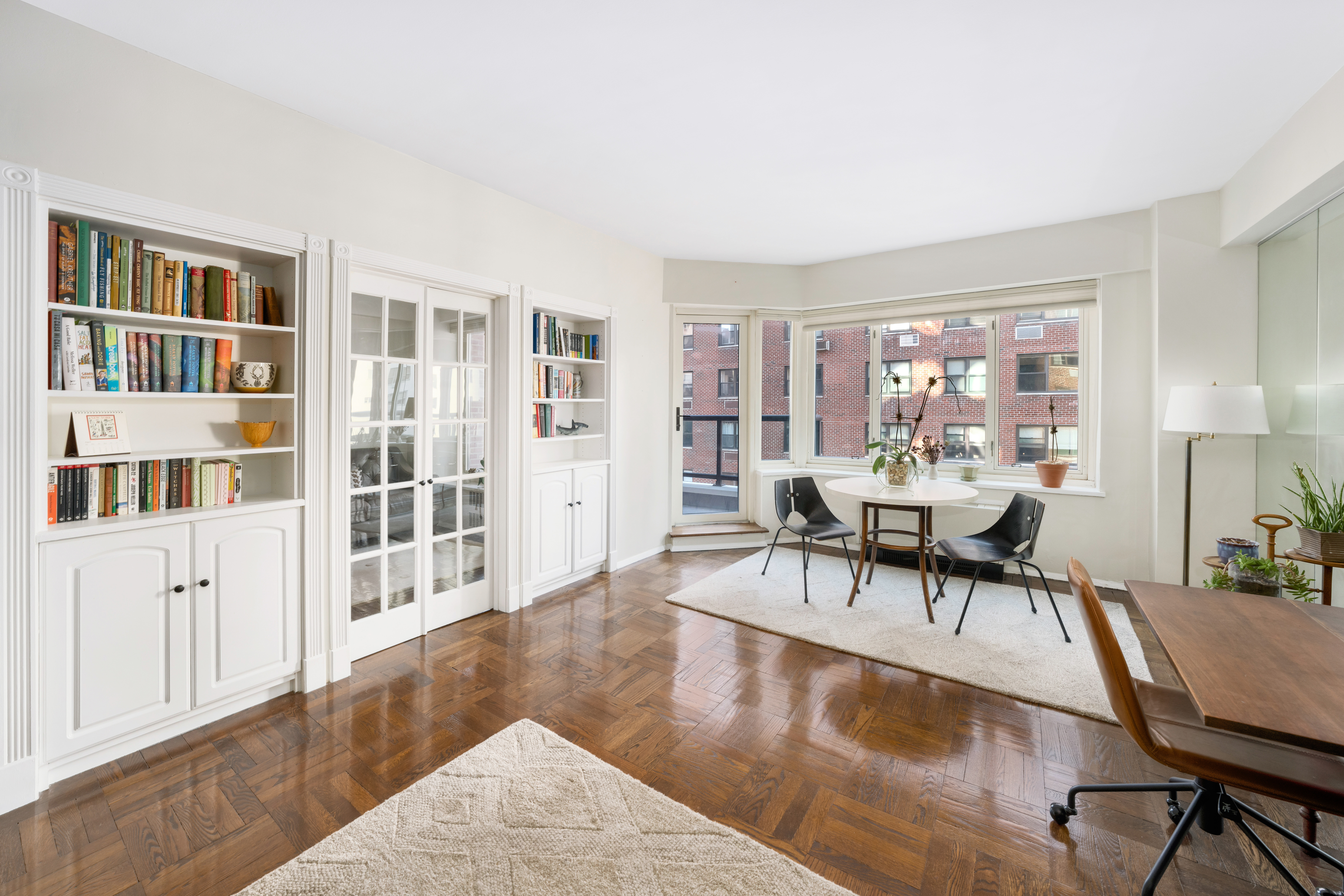 a view of a livingroom with furniture window and wooden floor