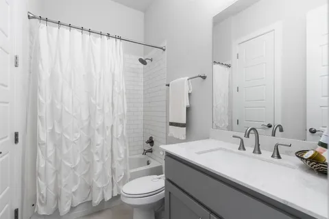 a bathroom with a sink toilet and shower