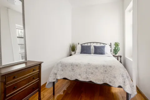 a bedroom with a bed and a dresser