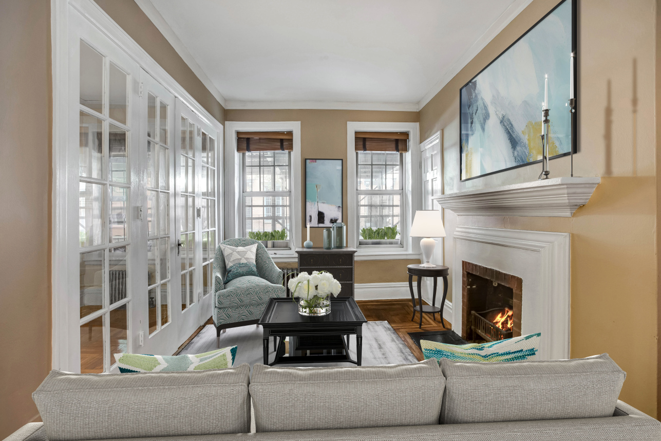 344 West 12th Street, Unit 1A Manhattan, NY 10014 - Photo 6 of 17 a living room with furniture a fireplace and a large window