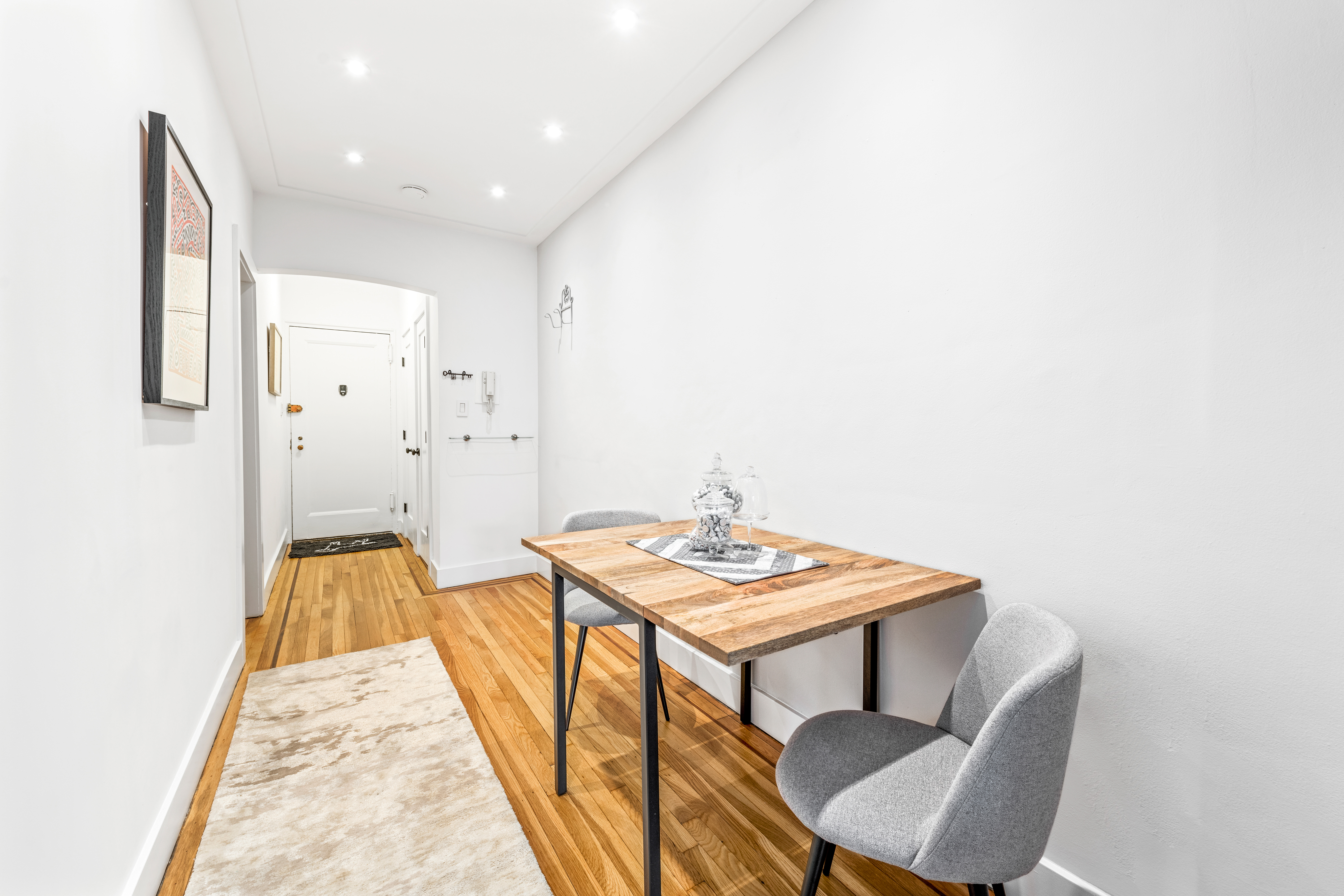 310 West 55th Street, Unit 5K Manhattan, NY 10019 - Photo 4 of 9 a view of a hallway with furniture and wooden floor